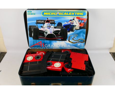 Scalextric -  A 1:64 scale Micro Scalextric A1 grand Prix Set (G1032). Item appears in good condition appear to contain most-