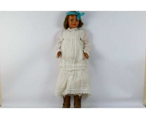 A large unmarked 'Walking Doll'. The doll with five piece composite body measures approximately 92cms in height. The composit