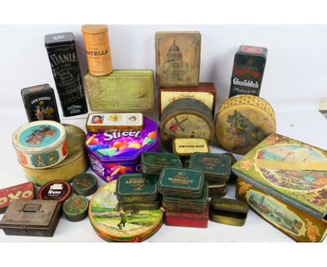 An assortment of mostly vintage storage tins in various sizes to include OXO, Jack Daniels and other RG