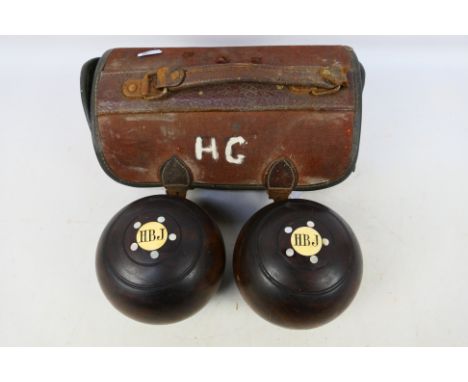 A pair of early 20th century E J Riley lawn bowls with ivory and mother of pearl inlay, 2½ bias, contained in bowls bag. [W]
