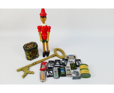 Mixed collectables to include vintage cigarette lighters, large brass key, wooden Pinocchio figure and other. [W]