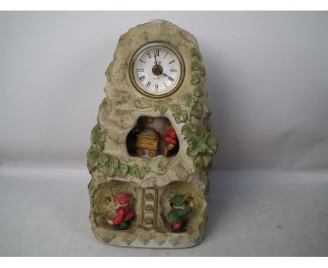 A novelty Melody In Motion Golden Mountain mantel clock, 34 cm (h). [W]

