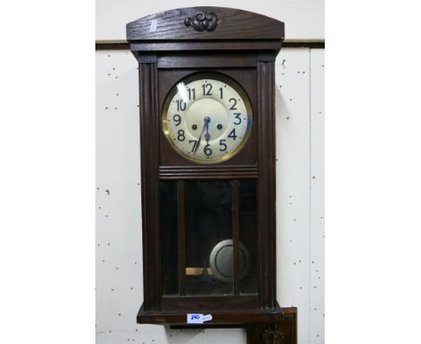 An oak cased wall clock with key and pendulum. [W]