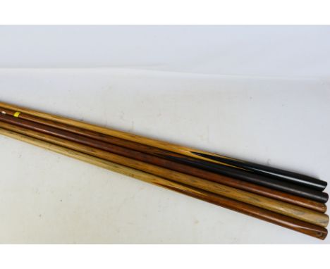 Four vintage snooker cues, largest approximately 146 cm (l). [W]

