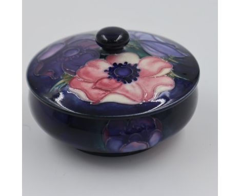 Moorcroft circular lidded powder box in the Anemone pattern, on a blue ground, large section re-glued, 11.5cm D. UK P&amp;P G