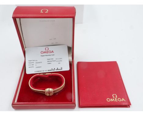 OMEGA: ladies 9ct gold cased wristwatch with 9ct gold bracelet, boxed with paperwork dating the watch to 1968, 18.1g. UK P&am