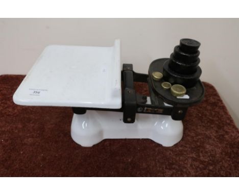 Set of vintage white enamel and cast metal kitchen scales with a selection of various assorted weights 