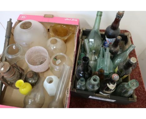 Selection of various assorted glass light shades and oil lamp chimneys, and a selection of glass bottles of various design an