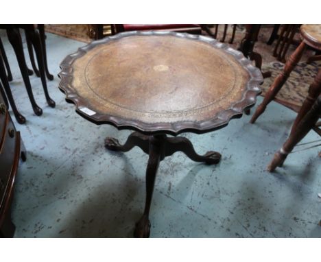 Small mahogany tilt top table with leather insert top and three out-splayed supports with ball &amp; claw feet (diameter 59cm