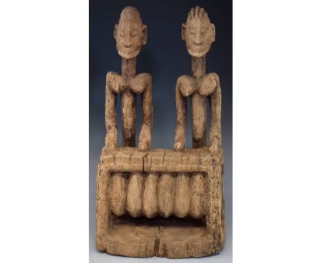 Dogon couple carved playing a balafon, 42cm high       All lots in this Tribal and African Art Sale are sold subject to V.A.T