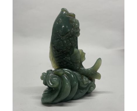 A large Chinese carved jade / hardstone figure of a fish jumping out of the water, H. 16cm.