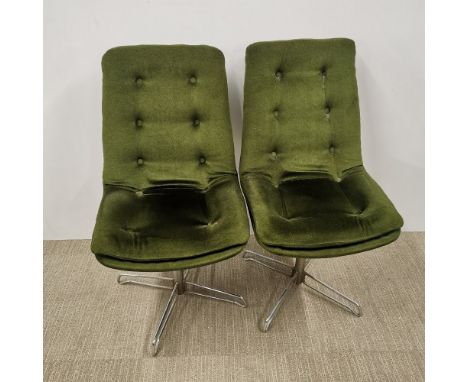 A pair of vintage revolving button backed chrome chairs upholstered in a green fabric, H. 92cm.