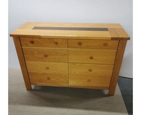 A heavy quality light oak eight drawer sideboard/ chest, 138 x 92 x 52cm.