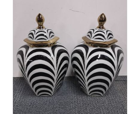 A pair of ceramic jars and lids, H. 40cm.