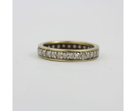 A yellow and white metal diamond set eternity ring, (M.5). One diamond missing.