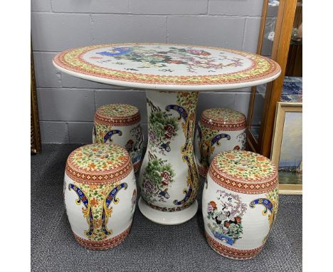 A Chinese ceramic garden table and four stools, table Dia. 89cm.