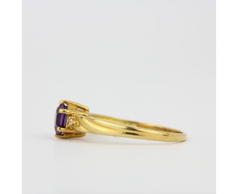 A hallmarked 18ct yellow gold ring set with a hexagonal cut amethyst, (O).