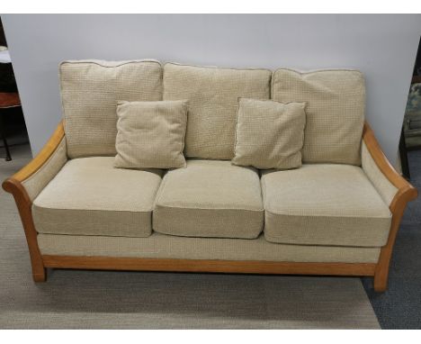 A light oak framed Gplan style three seater settee, L. 190cm H. 95cm W. 95cm.