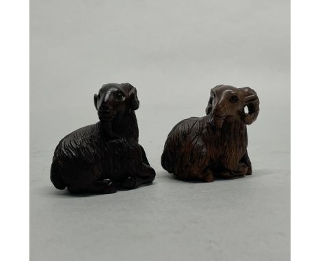Two Chinese carved wooden netsuke of rams, H. 4.5cm.