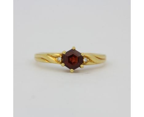 A hallmarked 18ct yellow gold ring set with a hexagonal cut tourmaline, (O.5).