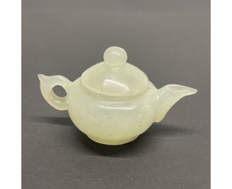 A Chinese carved jade / hardstone tea pot, H. 9cm.
