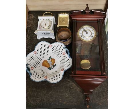 A wall clock, a porcelain mantel clock and three other items.