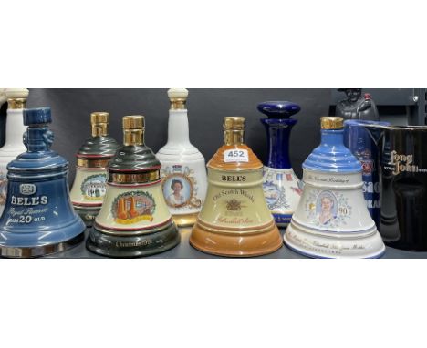 A group of Bell's whiskey ceramic bottles (empty), together with a Sandeman figure bottle (empty) and two bar jugs.