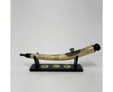 An Oriental bone opium pipe with stand, L. 30cm.