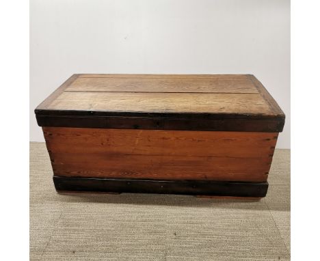 A vintage stained pine chest/ trunk, missing one iron handle, 108 x 52 x 50cm.
