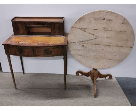 A three drawer mahogany writing desk with leather top together with a light wood circular folding table, desk 104 x 86 x 50cm