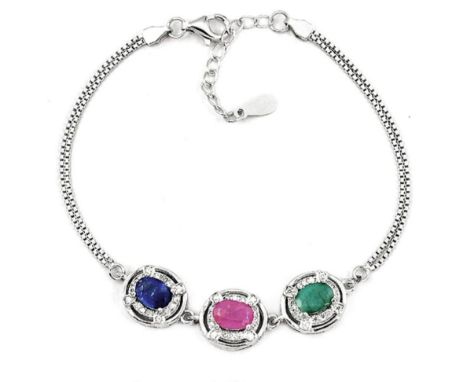 A 925 silver bracelet set with oval cut emerald, ruby and sapphire surrounded by white stones, L. 16cm.