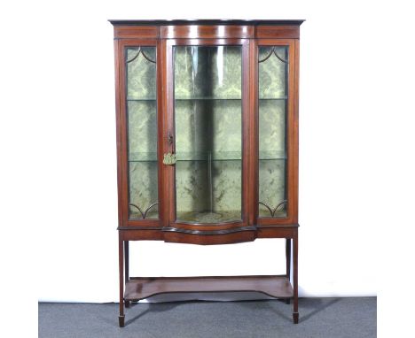 Edwardian inlaid mahogany bowfront display cabinet, the glazed door and panels enclosing two glass shelves, square tapering l