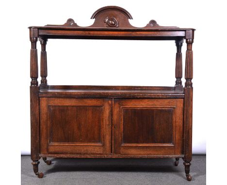 Victorian oak chiffonier, arched pediment, the top shelf with turned supports, two panelled doors below, turned legs on caste