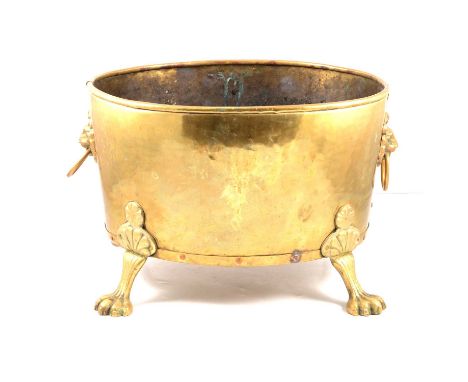 Edwardian brass log bin, oval with twin lion ring mask handles, paw feet, 36x43cm, height 30cm.
