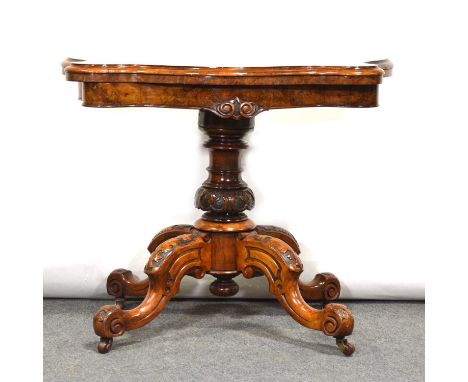 Victorian burr walnut card table, serpentine foldover top with baize lined interior, turned and carved column on four scrolle