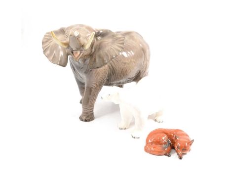 Three Beswick animal figurines, Elephant with trunk stretching, 36cm long, 26cm high (feet restored); Polar Bear model 1533, 