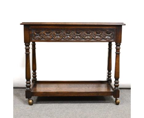 Oak two tier tea trolley, with carved frieze drawer turned legs joined by a shelf, on casters, width 80cm, depth 46cm, height