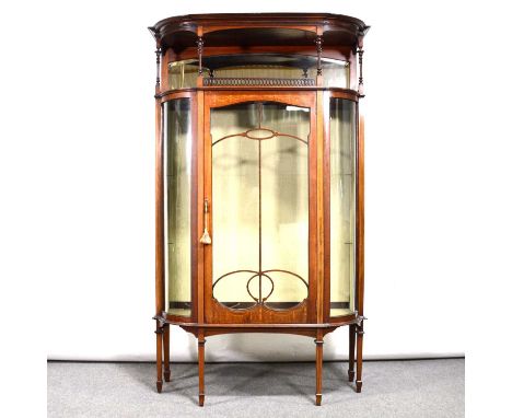 Edwardian inlaid mahogany bowfront display cabinet, moulded cornice, open shelf with pierced gallery above a glazed door and 