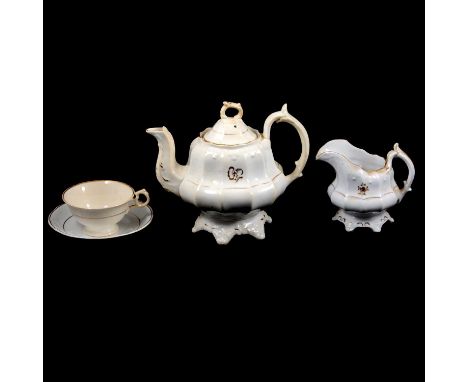 19th Century Staffordshire part tea service, the white ground decorated with sprays of flowers in gilt, comprising a teapot a