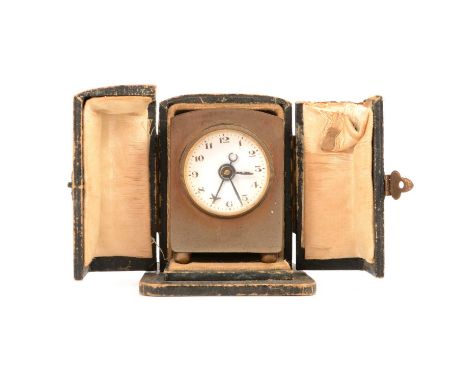 A small French brass travel clock, the 22mm circular white enamel dial with arabic numerals and subsidiary alarm hand, in bra