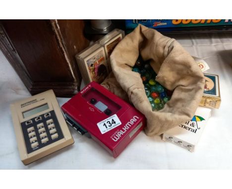 A quantity of marbles, Walkman, calculator and packs of playing cards