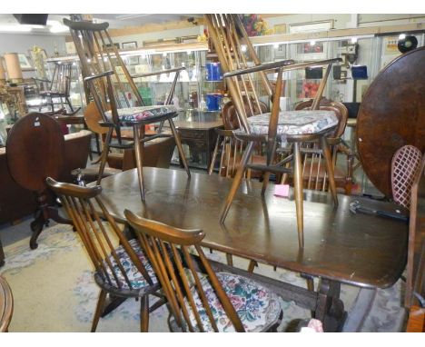 An Ercol dining table with six Ercol dining chairs, COLLECT ONLY.