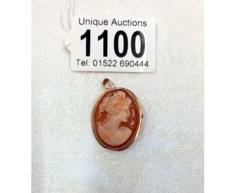 An oval cameo brooch and pendant carved with a portrait of a maiden on shell and mounted in 9ct gold.