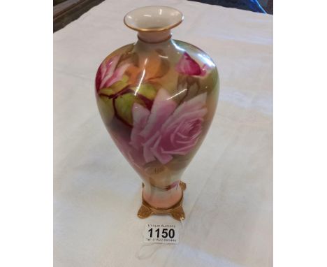 A Royal Worcester vase on four gilt feet, finely painted with English roses in the manner of James Hadley, green printed mark