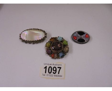 Two Celtic style brooches and one other.