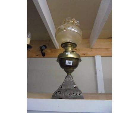 An oil lamp on metal base with brass font and later shade, COLLECT ONLY.
