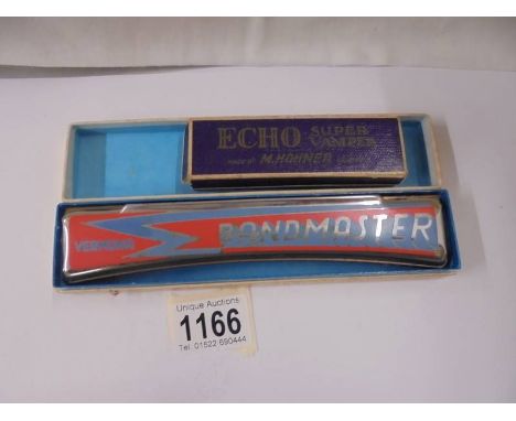 A Vermona Bandmaster harmonica and a Hohner Echo Superstomper harmonica.