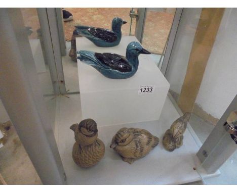 Four Poole pottery bird figures.