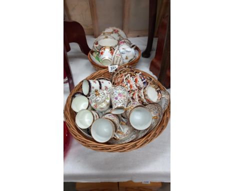 3 vintage tea sets in wicker basket including Royal Worcester plus small basket of cups and saucers plus a trio