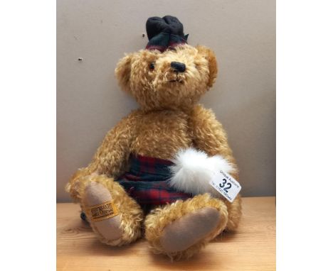 A Merrythought bear in a kilt and with growler